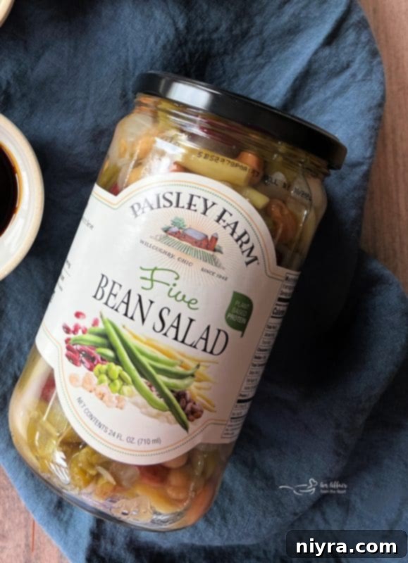 A serving of Five Bean Baked Beans in a smaller bowl, ready to be enjoyed as a side.