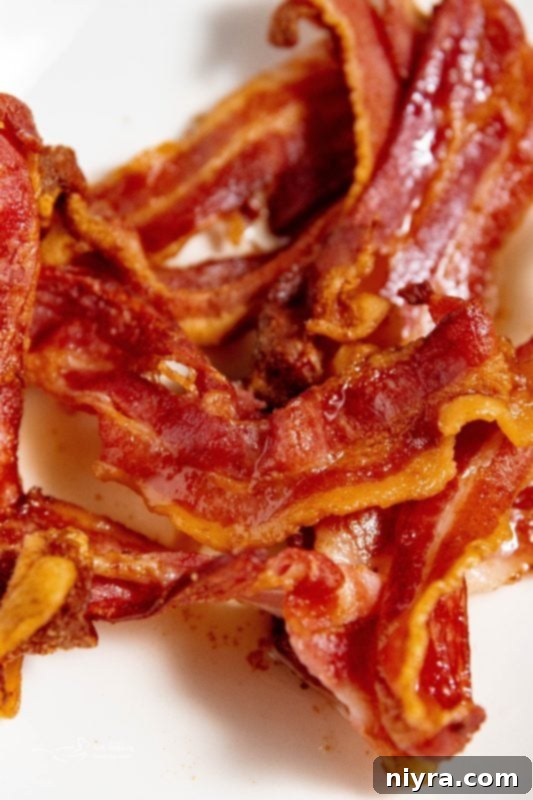 Freshly cooked bacon in an air fryer basket