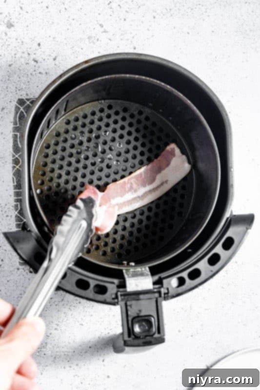 Bacon laid in a single layer in the air fryer