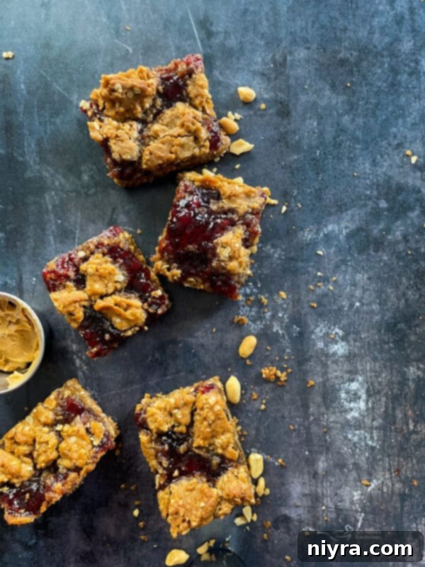 Stack of two PB&J Oatmeal Cookie Bars with a bite taken out of the top one