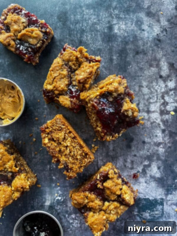 A close-up of a single PB&J Oatmeal Cookie Bar on a white plate