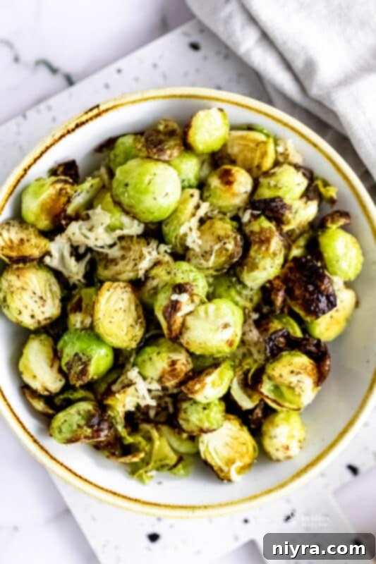 Crispy Air Fryer Zucchini 17 Air Fryer Brussels sprouts in a white serving bowl.