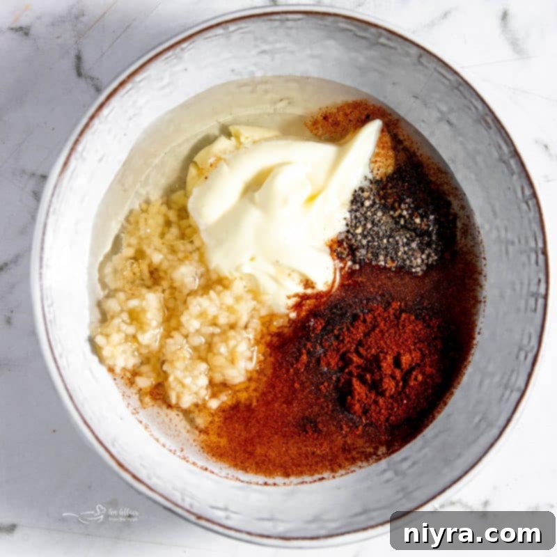 Step 1: Whisking together olive oil, mayonnaise, vinegar, garlic, and smoked paprika for the dressing in a small bowl