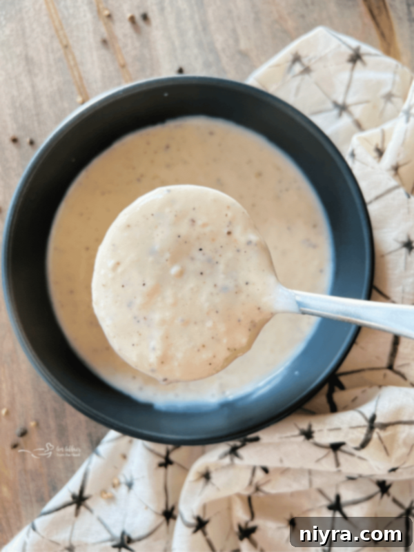 Fluffy Buttermilk Biscuits 4 simple white country gravy close up in a serving ladle