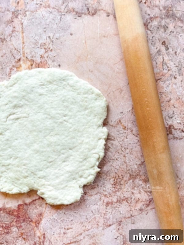 Fluffy Buttermilk Biscuits 9 Mixing buttermilk into dough with a fork