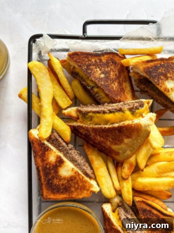 A hearty Dunker Burger, piled high with toppings, served on a plate with fries.