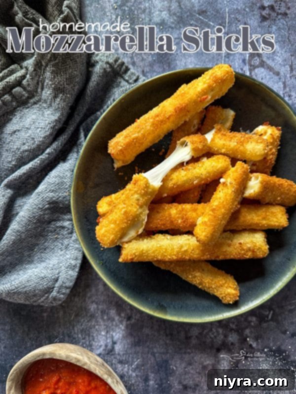 A hero shot of golden, crispy homemade mozzarella sticks, piled high and inviting, ready to be enjoyed.