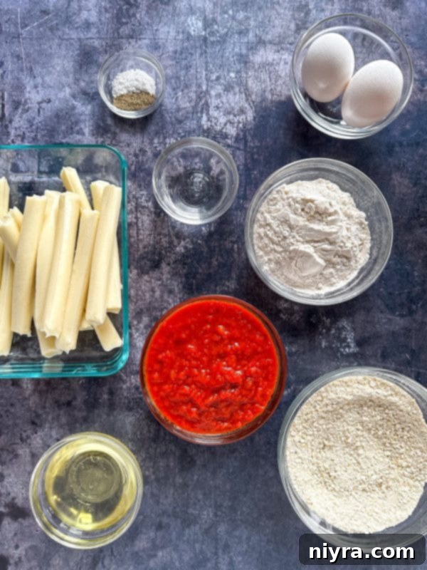 Three golden-brown homemade mozzarella sticks sit on a rustic wooden board, accompanied by a small bowl of marinara sauce.
