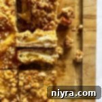 Close up of Apple Pie Crumb Bars on their side so we can see the inside