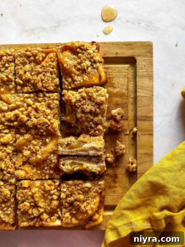 Apple Pie Crumb Bars stacked on a white plate