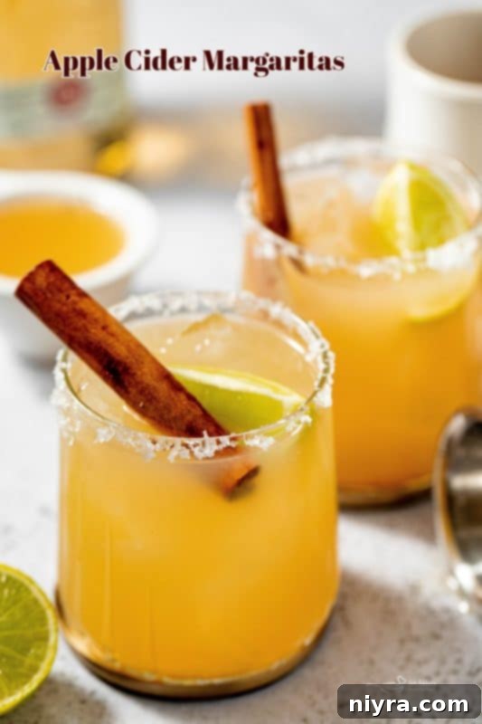 Apple Cider Margarita 15 A stunning hero shot of a perfectly garnished Apple Cider Margarita with a cozy fall background.