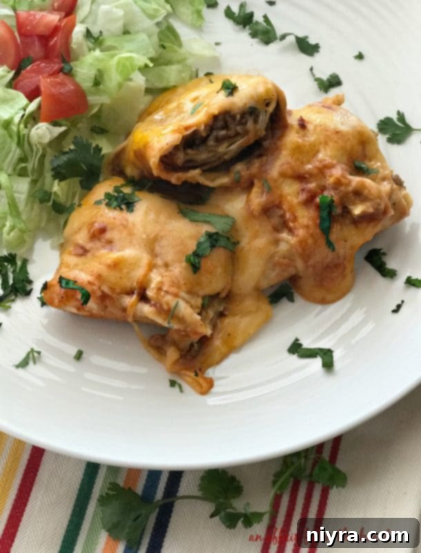 Close-up of a perfectly cooked slow cooker smothered burrito, ready for toppings.