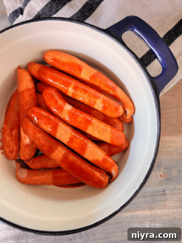 BBQ sauce and water mixed over hot dogs