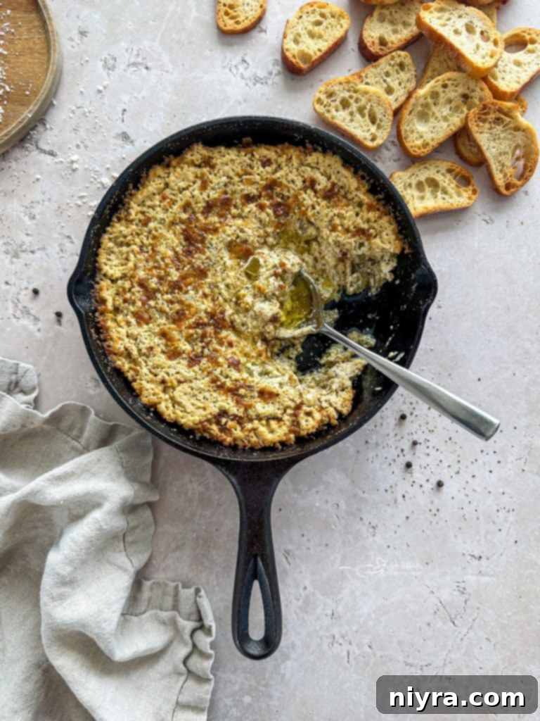 Baked Onion Dip in a baking dish with a spoon