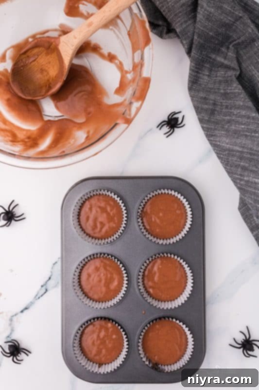 Mixing wet and dry ingredients for cupcakes