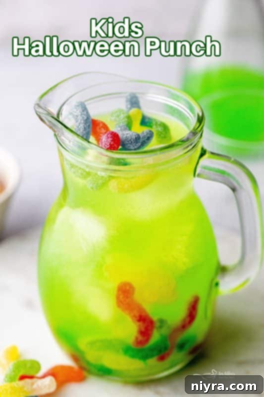 Hero image of Halloween Kids Punch in a pitcher with glasses and sour worms.