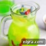 Jug full of Halloween kids punch topped with gummy worms