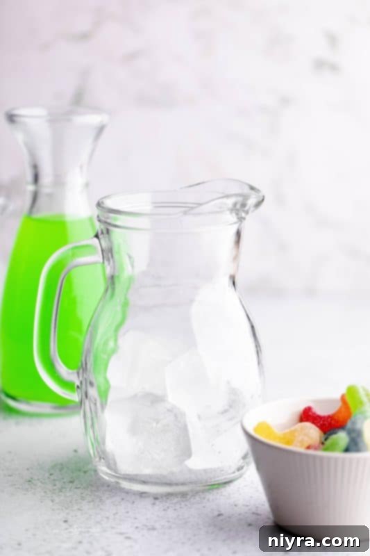 Step 1: Filling a pitcher with ice for Halloween Kids Punch.