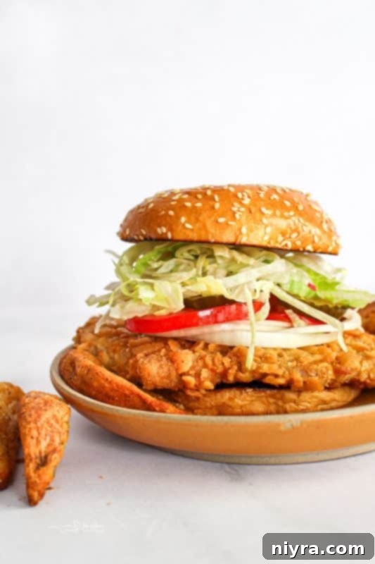 Crispy Pork Tenderloin Sandwich 2 Classic Breaded Pork Tenderloin Sandwich on a bun with toppings