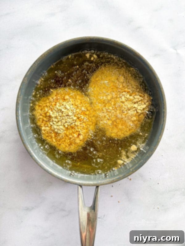 Crispy Pork Tenderloin Sandwich 11 Step-by-step: coating pork chop in cracker crumbs