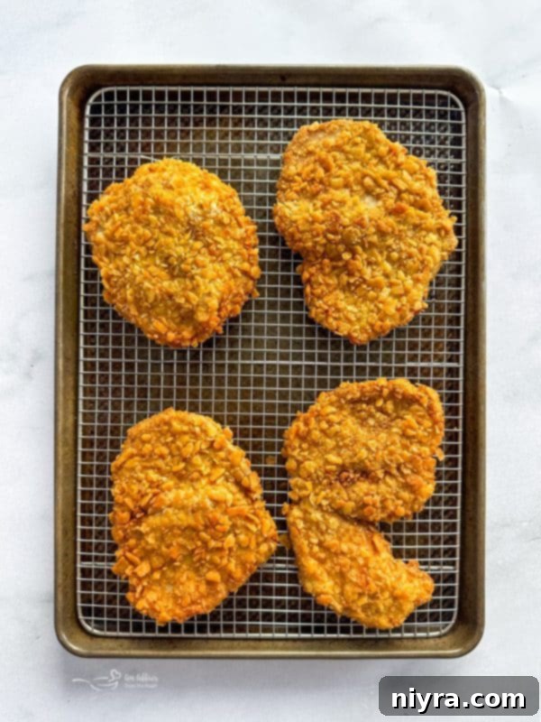 Crispy Pork Tenderloin Sandwich 12 Step-by-step: frying breaded pork tenderloin in a skillet