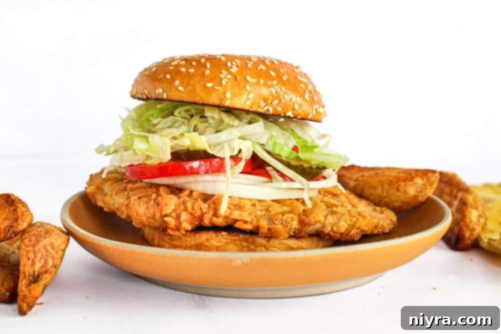 Crispy Pork Tenderloin Sandwich 16 Close-up of a breaded pork tenderloin sandwich, showing its generous size