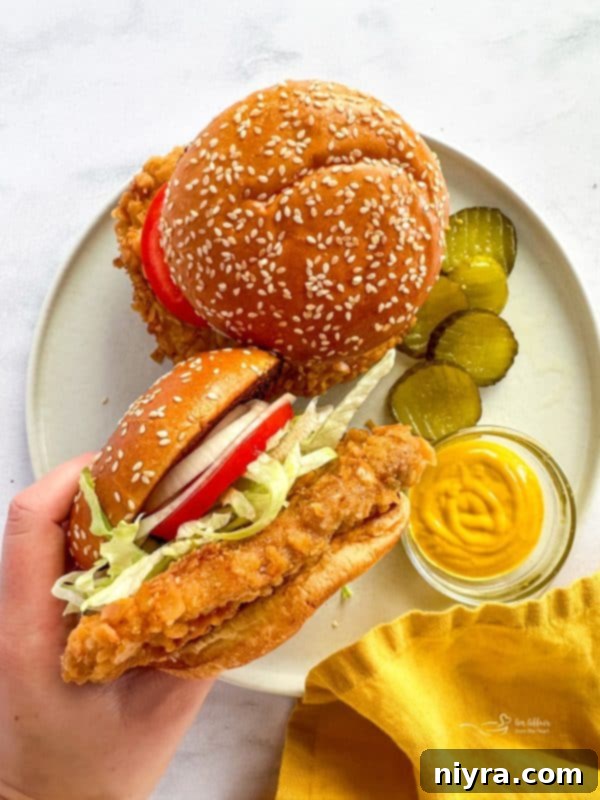 Crispy Pork Tenderloin Sandwich 3 Close up of a breaded pork tenderloin on a plate, ready for the bun