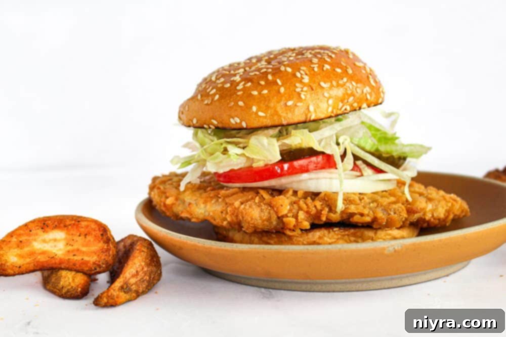 Crispy Pork Tenderloin Sandwich 4 Two breaded pork tenderloin sandwiches on a cutting board, with various toppings