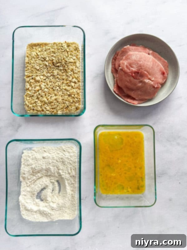 Crispy Pork Tenderloin Sandwich 8 Step-by-step: setting up the breading station with flour, egg, and cracker crumbs