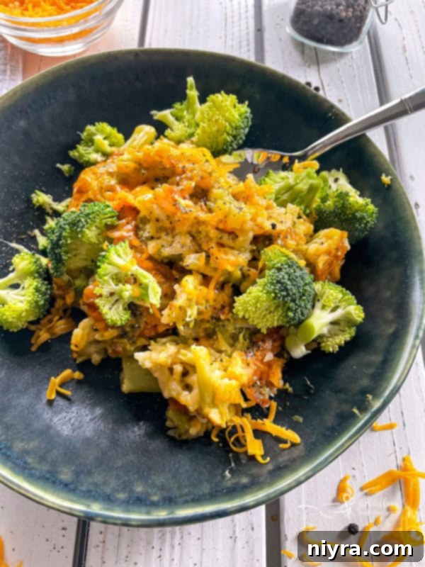 Top view of broccoli, rice, and cheese casserole on top of dark plate