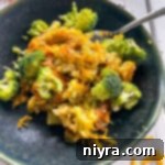 Top view of broccoli, rice, and cheese casserole on top of dark plate