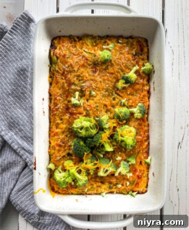 Top view of cooked broccoli and cheese casserole in a baking dish topped with broccoli