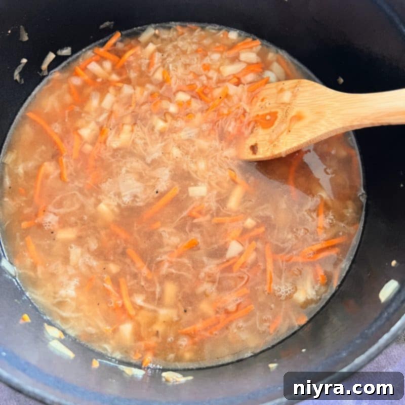 Step 5: Covering all ingredients with chicken stock.