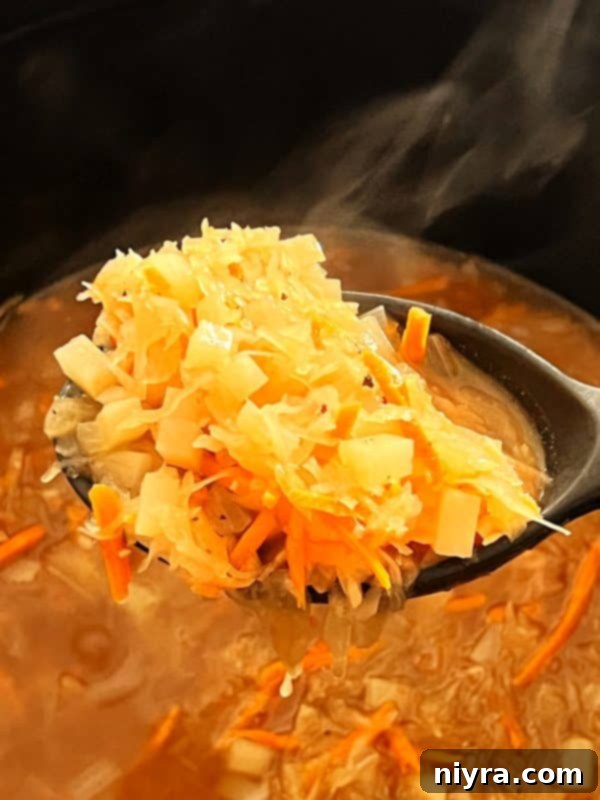Step 6: Pureeing the French Sauerkraut Soup with an immersion blender.
