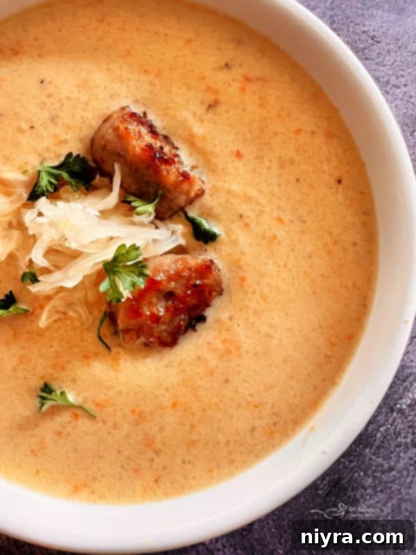 A bowl of French Sauerkraut Soup with a spoon, highlighting its creamy texture.
