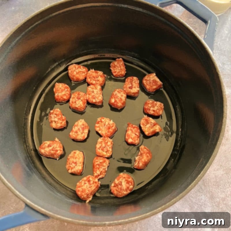 Step 1: Sautéing sliced bratwurst in a soup pot.
