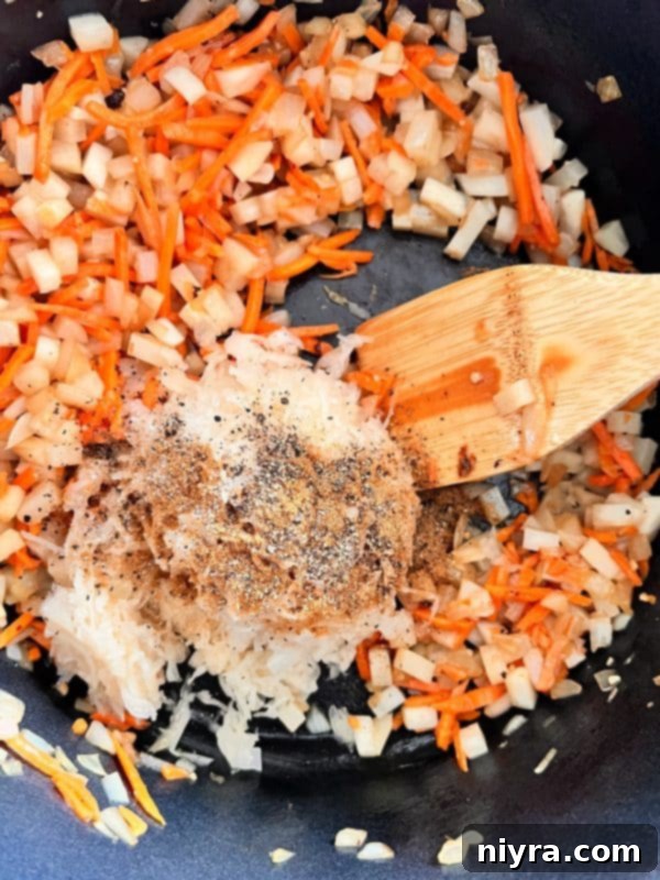 Step 4: Stirring spices and sauerkraut into the sautéed vegetables.