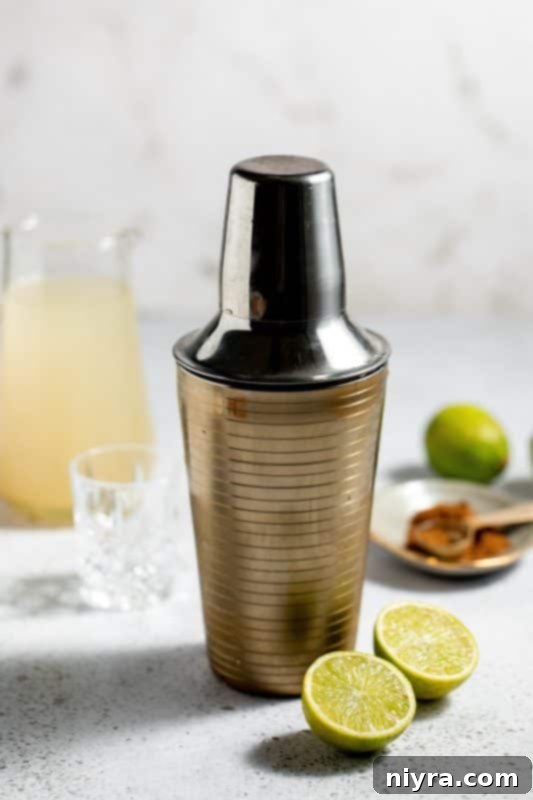 Shaking the cocktail shaker vigorously.