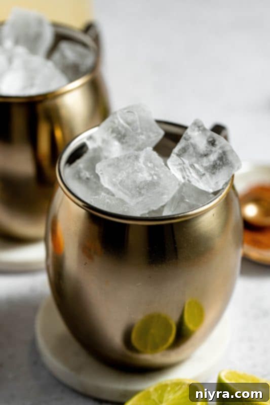 A copper Moscow Mule mug filled with ice.