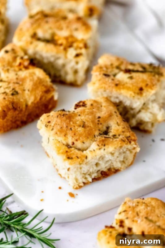 A close-up of the crispy edge of a slice of focaccia bread