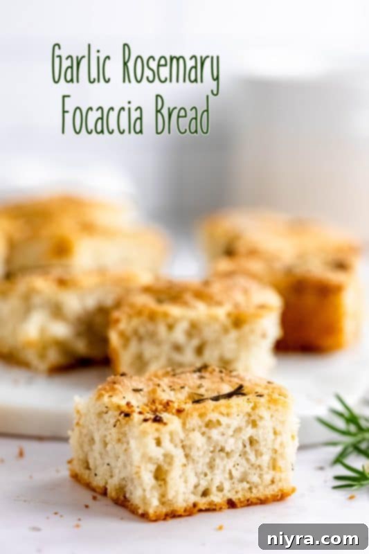 Hero shot of a freshly baked Garlic Rosemary Focaccia Bread, garnished with rosemary sprigs