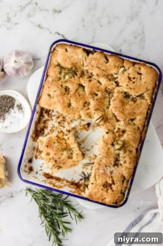 A close-up of the airy texture inside a slice of Garlic Rosemary Focaccia Bread