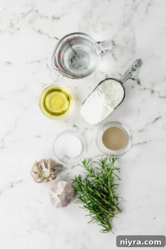 Close-up of the signature dimples in focaccia dough before baking