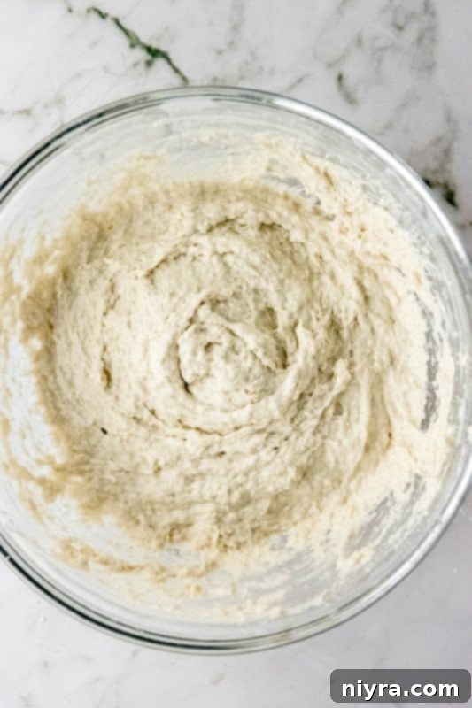 Focaccia dough being mixed by hand or with an electric mixer