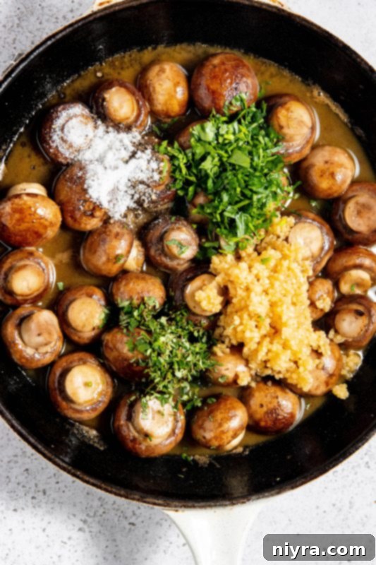 Garlic, parsley, thyme, salt, and pepper added to mushrooms in cream sauce.