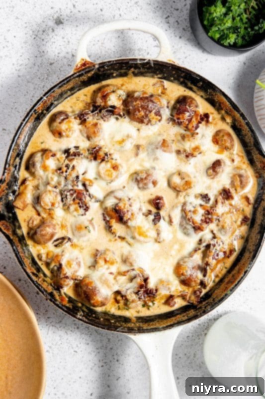 All the ingredients for Creamy Mushrooms and Bacon laid out on a cutting board.