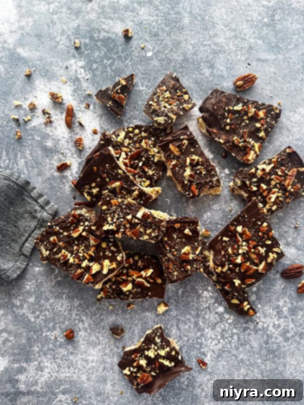 Homemade toffee with a chocolate and nut topping, broken into pieces