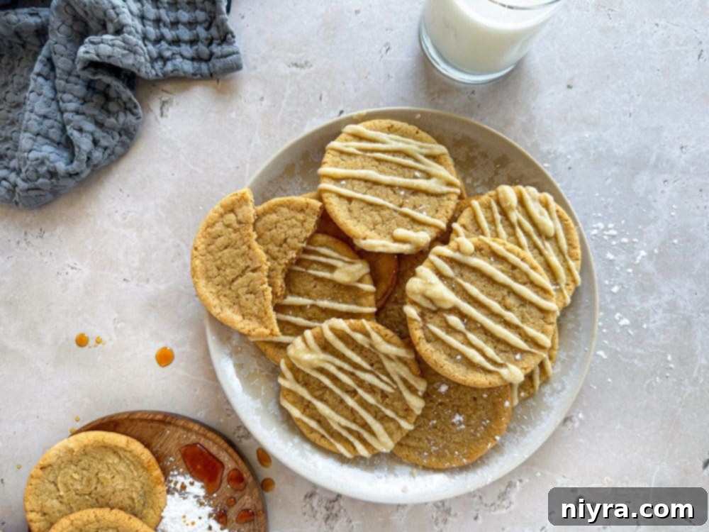 Golden Maple Delights 14 A large batch of freshly iced maple sugar cookies arranged on a wooden serving board.