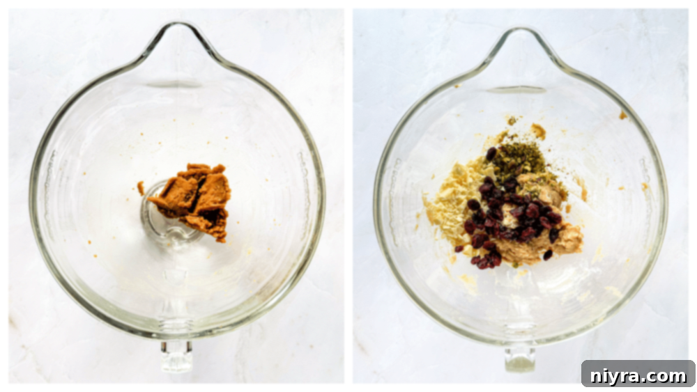 Festive Biscotti 6 Close-up of butter, brown sugar, and white sugar being creamed in a bowl.
