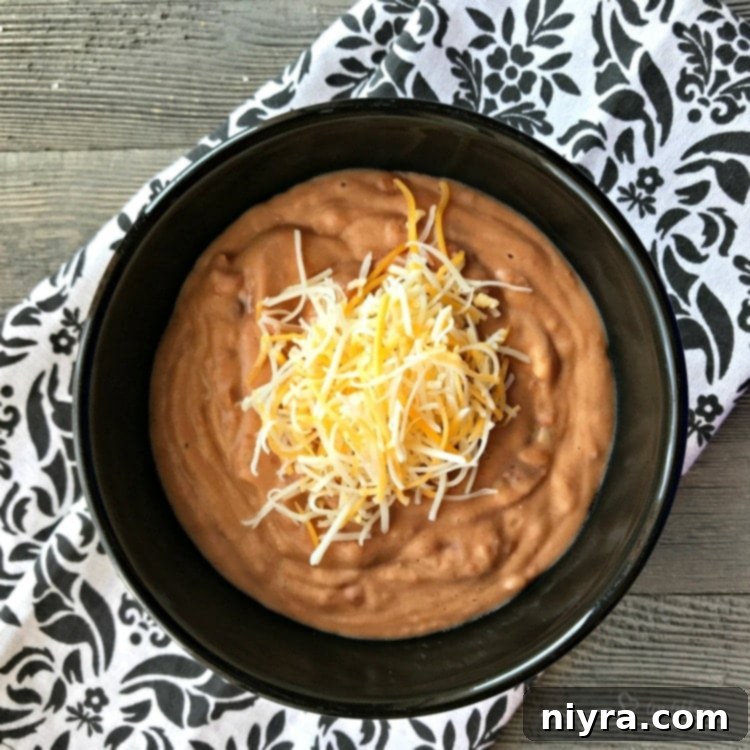 The secret to amazing restaurant-style refried beans Restaurant Style Refried Beans in a bowl with tortilla chips